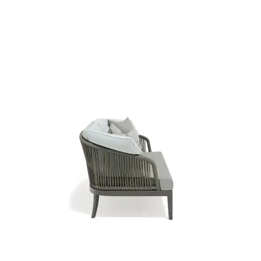 Studio shot of the DREAM Sofa by Atmosphera, an outdoor sofa with rope-woven backrest and plush cushions.