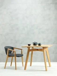 KNIT outdoor dining armchair and square dining table in teak and woven rope in an outdoor setting