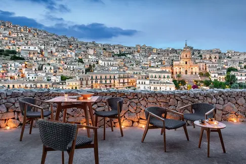 KNIT square outdoor dining table and dining chairs in teak with city views