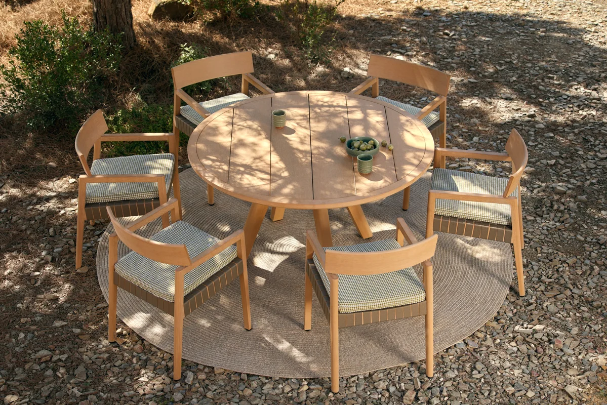 Kubik round outdoor dining table and chairs showing warm TechTeak tones and refined outdoor dining detail.