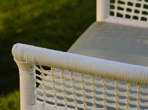 Close-up of the woven back on a white ESCALA Dining Armchair