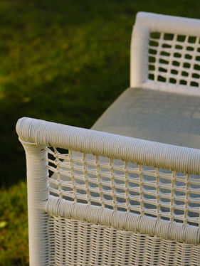 Close-up of the woven back on a white ESCALA Dining Armchair
