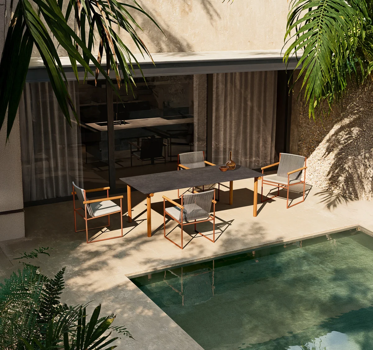Atmosphera Pipe armchairs and side table beside a sheltered courtyard pool