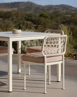 CURIO Dining Chair positioned on a stylish outdoor deck.