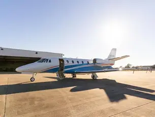 Private jet on airport tarmac representing a private jet charter from New York to Miami