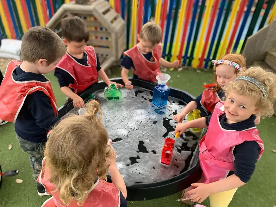 Preschoolers exploring water play at a Woking preschool