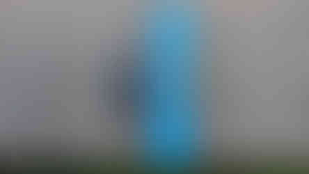 Z-seat folded up, beside a pair of sunglasses for scale