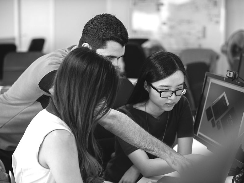 man teaching two woman_edited.jpg