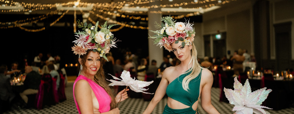 Two roving performers dressed in long dresses and floral gowns meeting guests at wedding reception in The Centeal Coast NSW