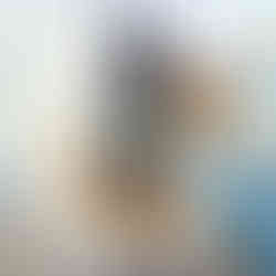 Dancer posing on a jetty in sunset dressed in gold dress and gold goddess like head piece