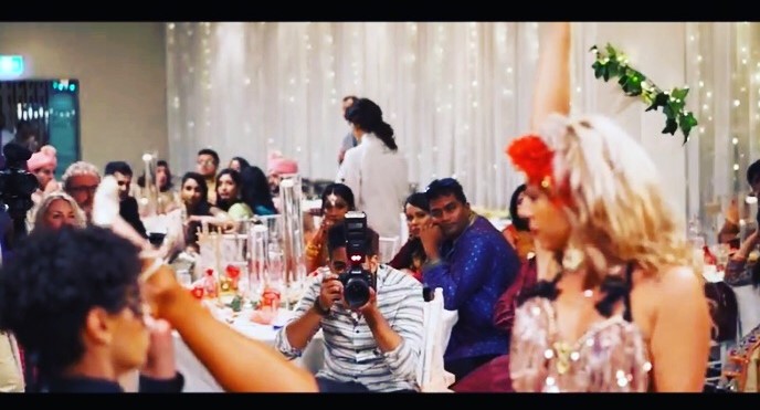 two dancers performing a Latin Wedding Show with guests and a photographer at a wedding in Sydney