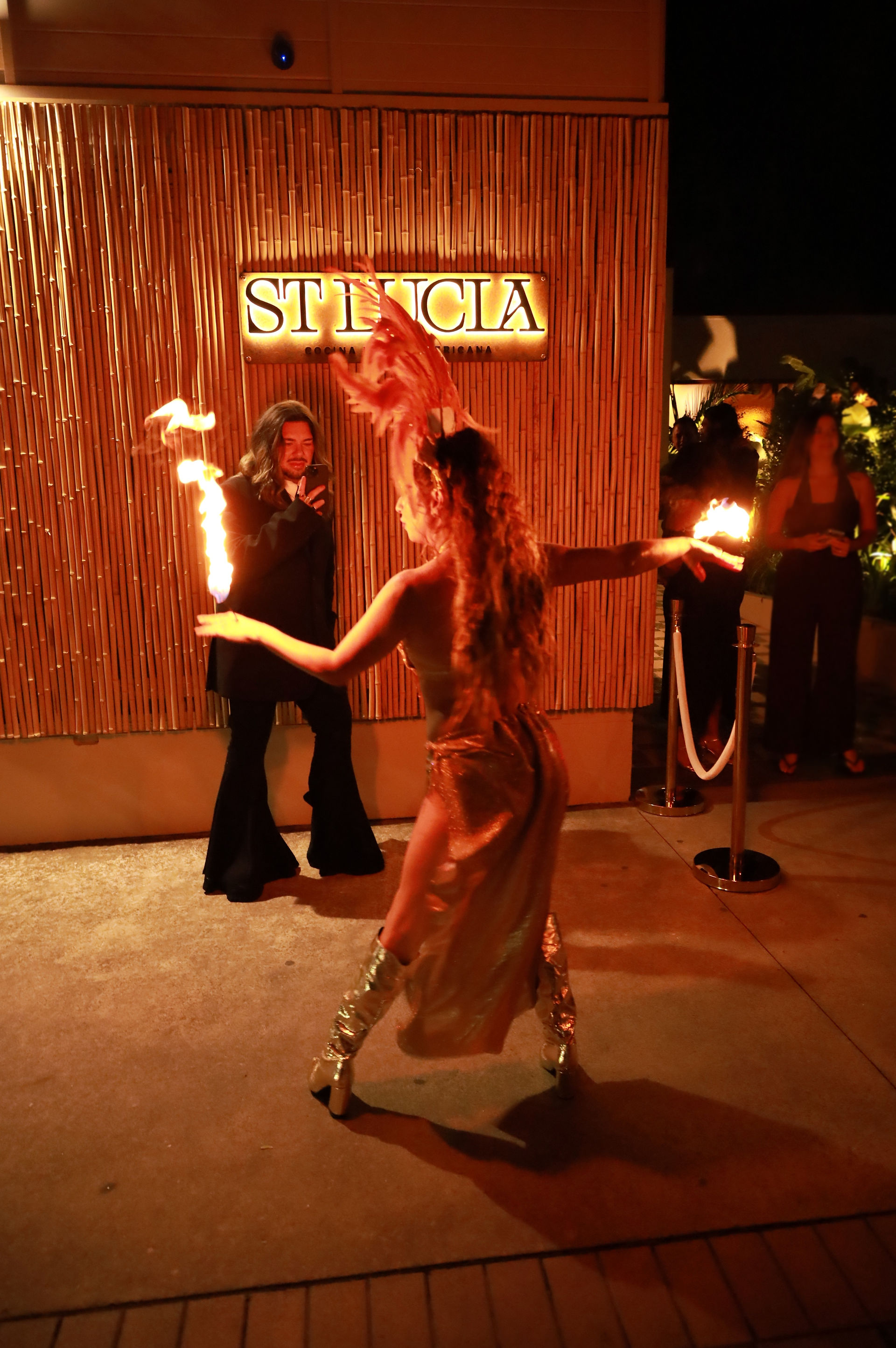 Fire dancer dressed in samba costume dancing with fire