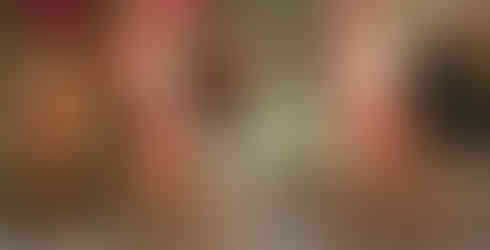 three samba dancers dressed in pink carnival costumes performing at wedding