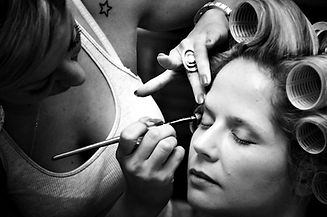 Bride getting her makeup done by makeup artist for her wedding day
