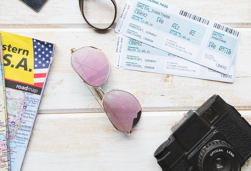 Map, boarding passes, sunglasses, and a camera on wooden table. Map is titled “Western USA.” Passes list Frankfurt and Vancouver. Travel vibe.