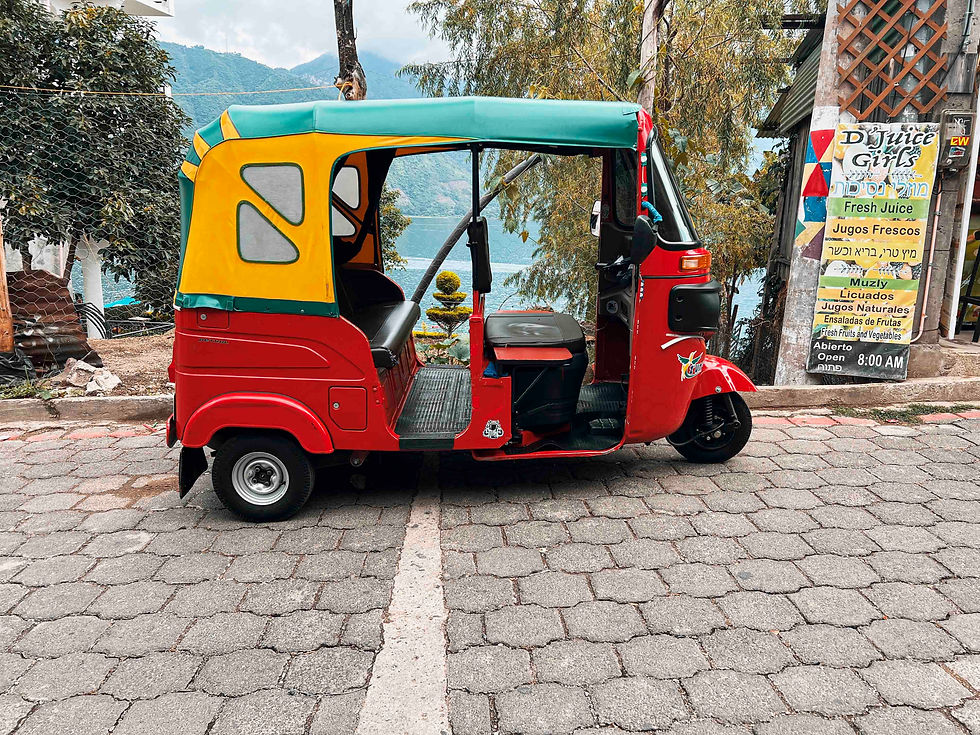 A Guatemalan tuk tuk with Lake Atitlan in the background