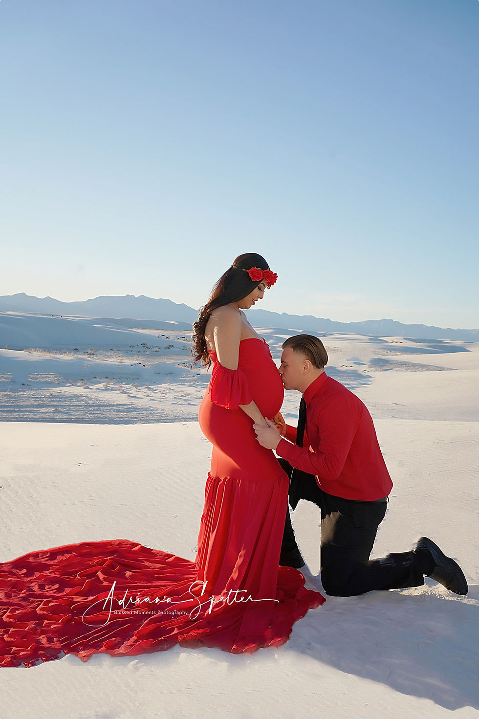 Husband kissing mama's belly at White Sands National Park.