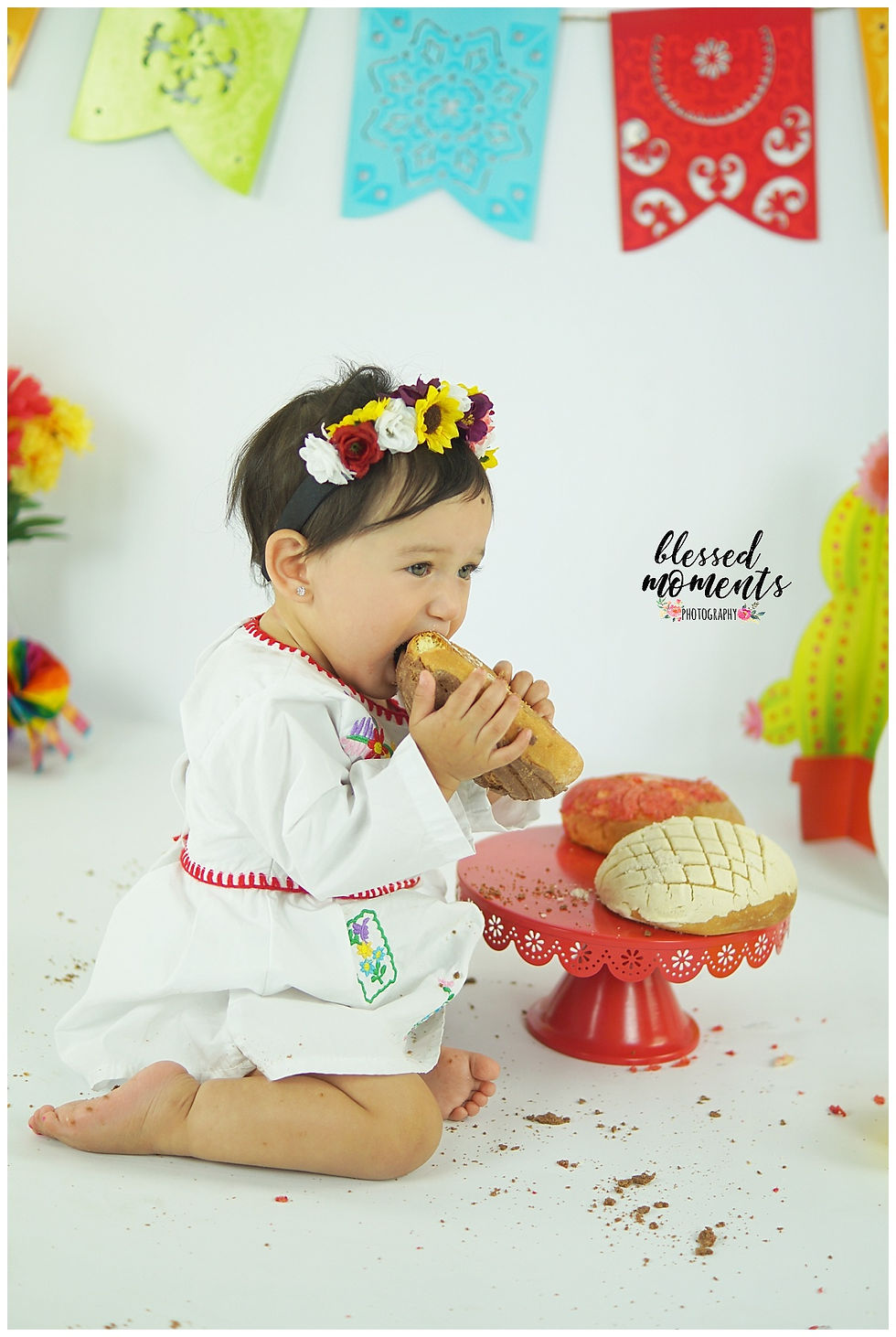 Fiesta photo session with little girl eating pan dulce
