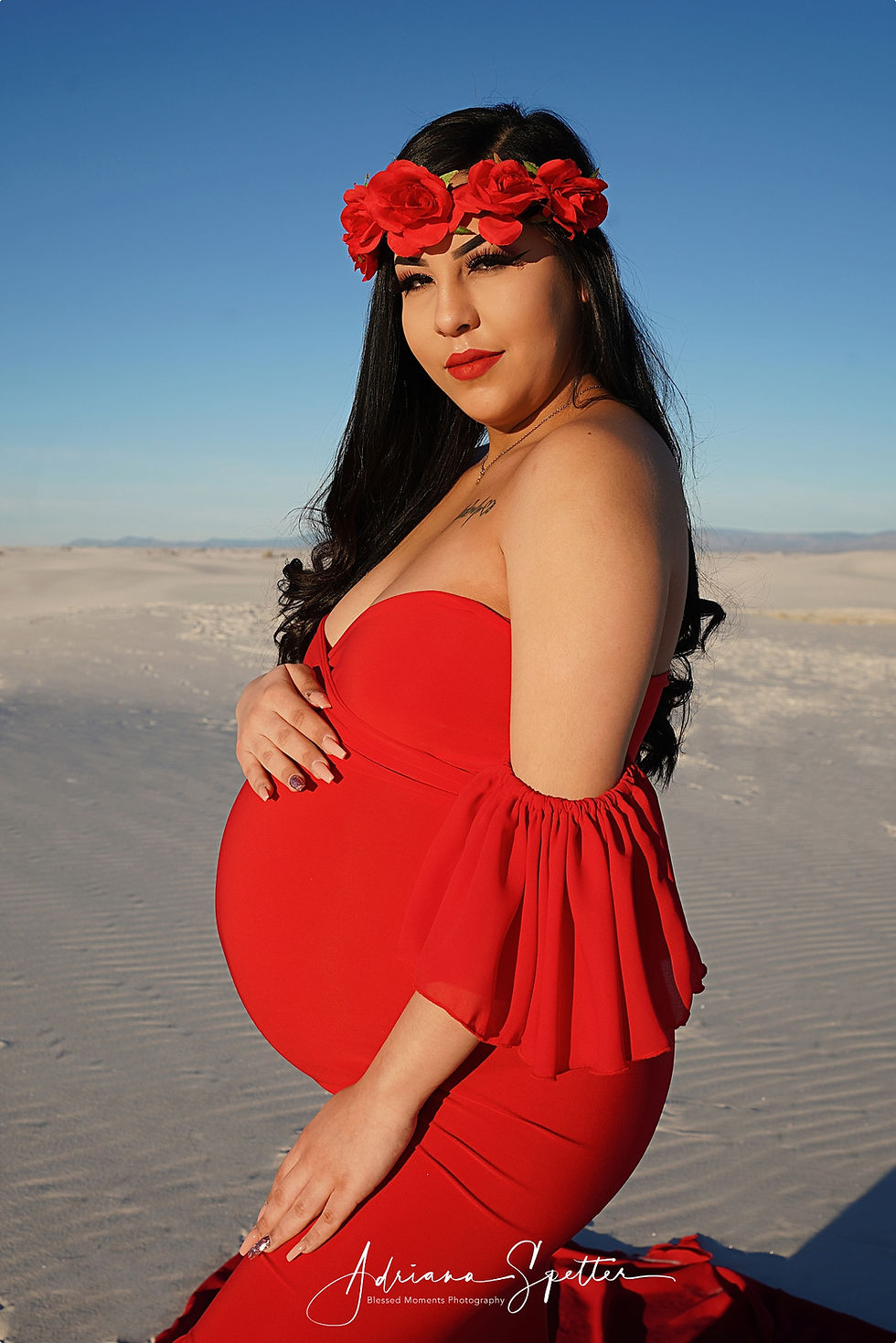 Stunning mama in a maternity photo at White Sands wearing a red dress