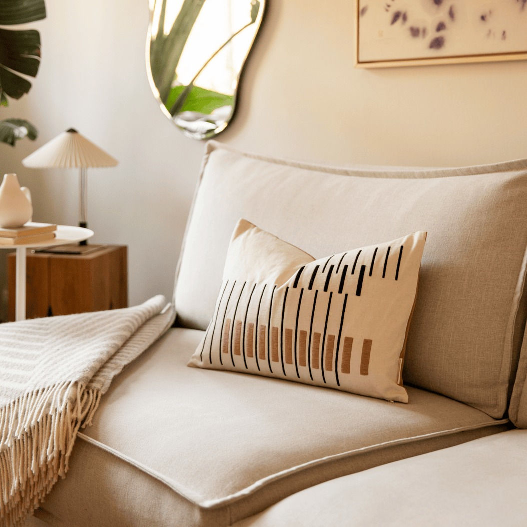 Striped bauhaus styled cushion on beige sofa in living room