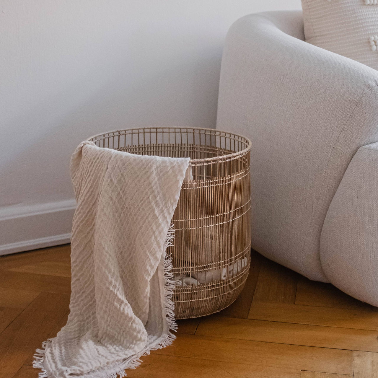 Natural woven basket next to sofa