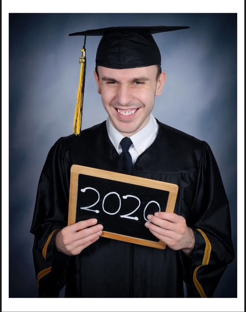 Theo in graduation cap and gown, portrait orientation