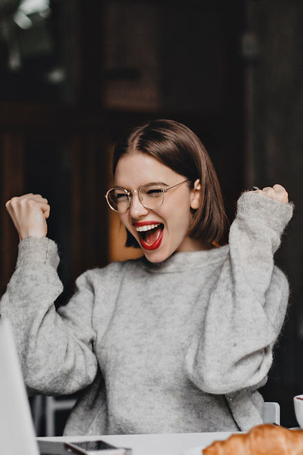 happy-woman-glasses-makes-winning-gesture-sincerely-rejoices-lady-with-red-lipstick-dresse