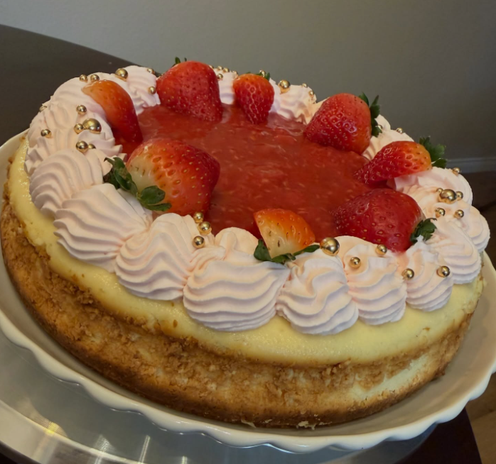 Close-up view of a slice of Strazzberry cheesecake on a white plate