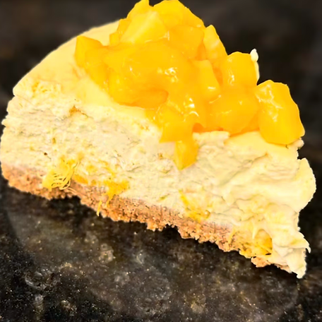 Slice of lemon cheesecake with yellow custard topping by Imperfect Cravings