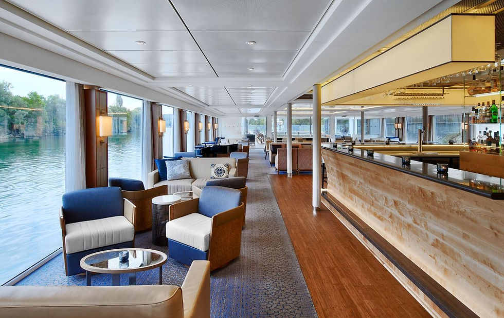 Viking river cruise lounge with panoramic windows, seating areas, and river views
