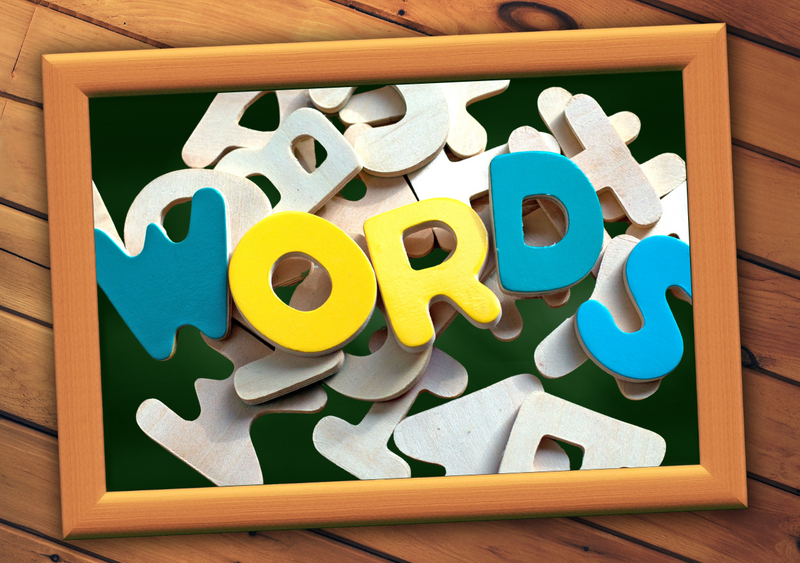 Picture frame with wooden letters scattered in the background with the word "WORDS" in color  