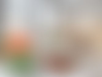 bao buns topped with seared steak, carrots, cilantro, and green onion on serving dishes