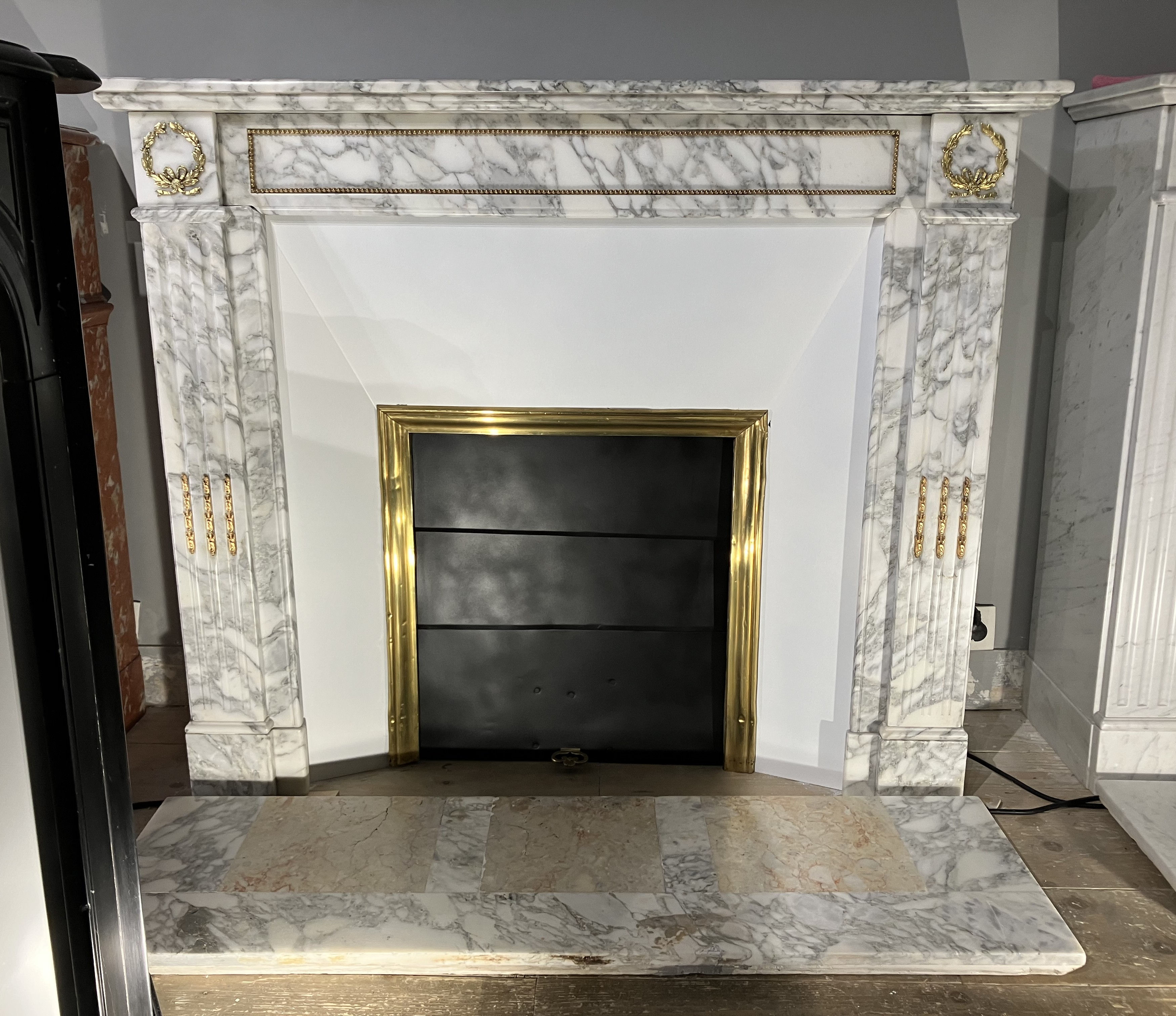 Antique LOUIS XVI style fireplace in white and gray marble with bronzes.