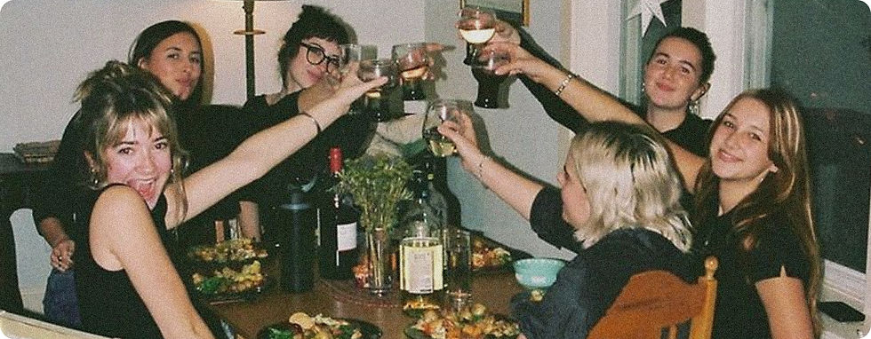 Lottery win financial advice: friends raising glasses at dinner.