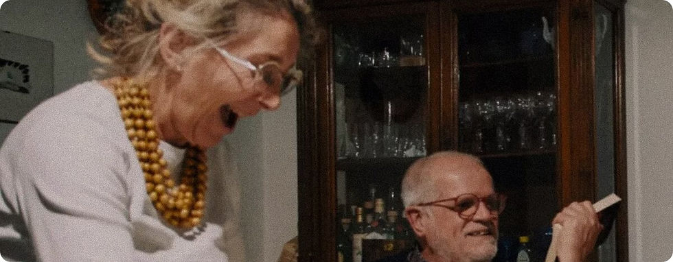Older couple laughing together at home.
