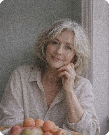 Retirement advice: older woman beside fruit on a table.