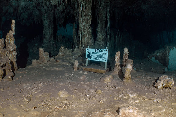 Stop sign for scuba divers in underwater cave, god of death with scythe.jpg