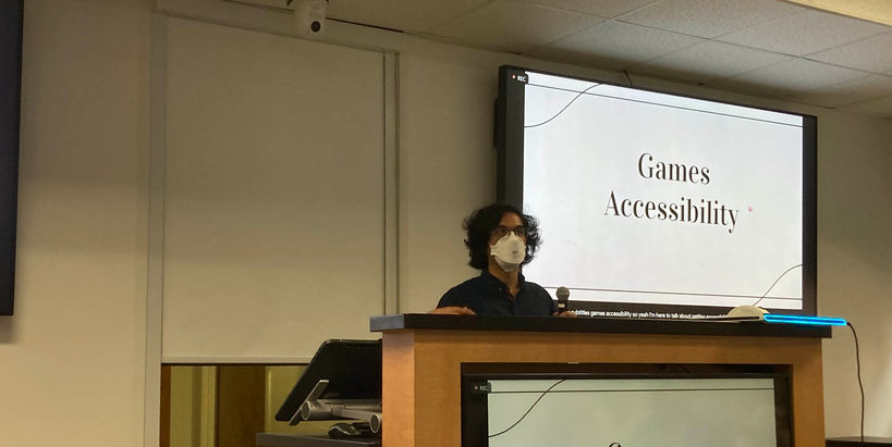Ziad stands at a podium. A screen behind him says: "Games Accessibility".
