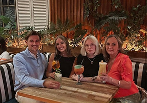 Group of 4 drinking cocktails