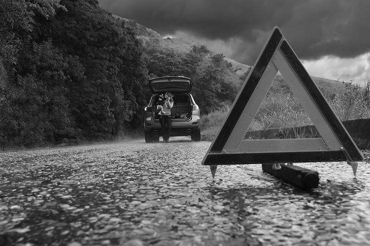 Broken down car with warning triangle