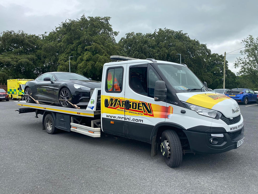 A car on a recovery van in a car park
