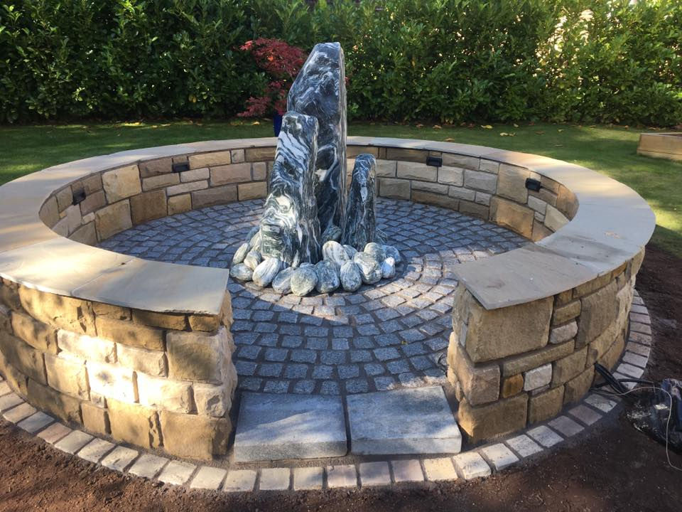 A paved area with rock centrepiece