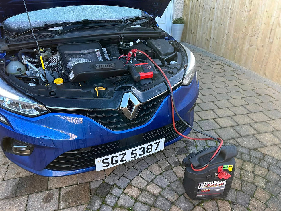 A battery being charged on a driveway