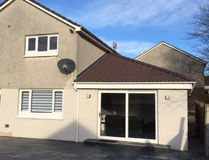 Family and utility room extension in Westhill featuring large sliding glass doors