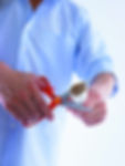 Man cutting cigarettes in half.jpg