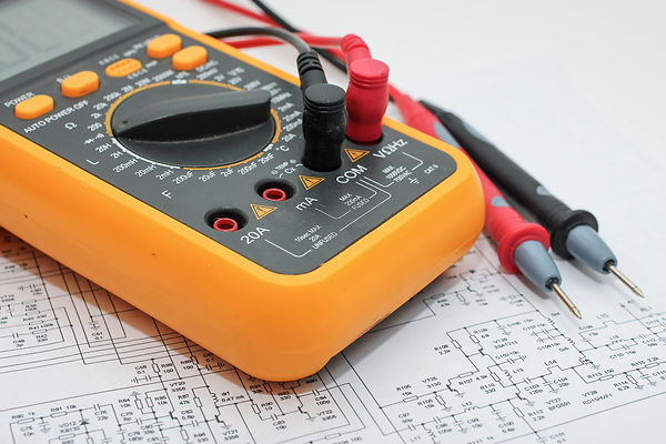 Volt meter resting on a circuit diagram
