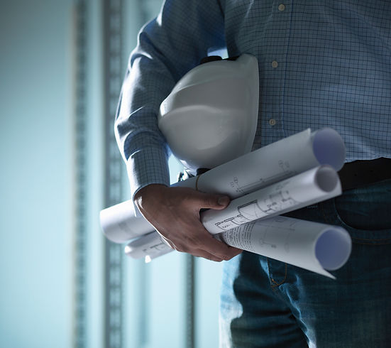 Man holding a hard hat and blueprints