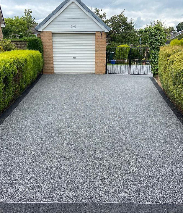 New drive leading to a garage and a gate