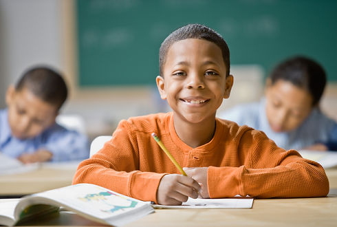 A young boy at a school desk