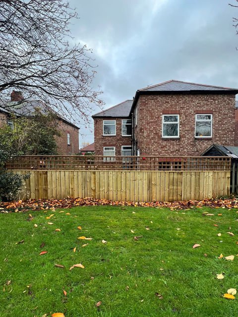 A garden fence with trellis top